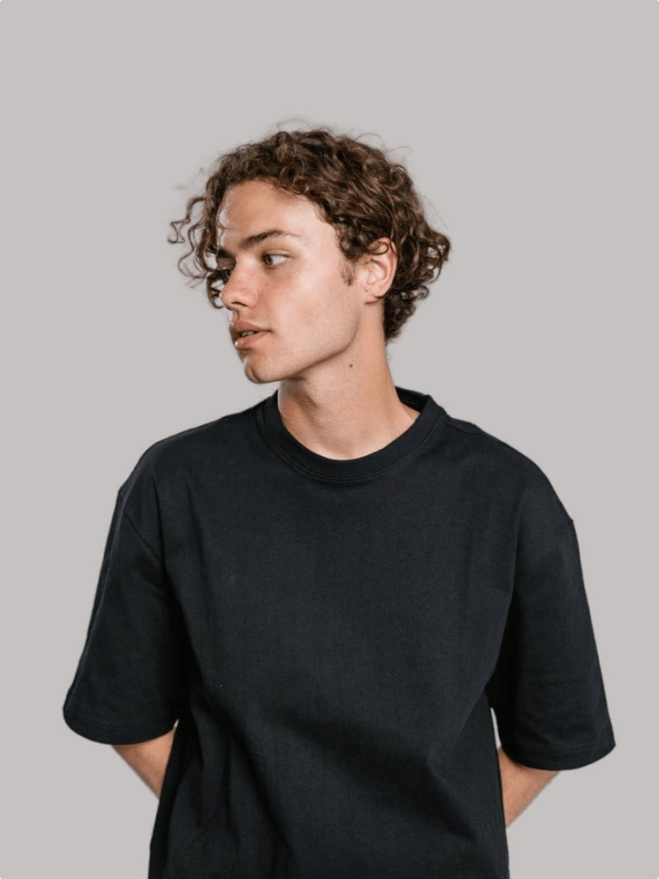 Man wearing black oversized drop shoulder t-shirt