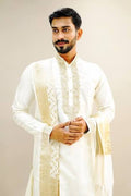 Man wearing cream kurta with golden embroidered dupatta