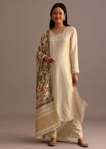 Woman wearing cream embroidered kurta set with printed dupatta