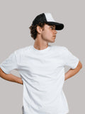 Man wearing plain white crew neck t-shirt and cap